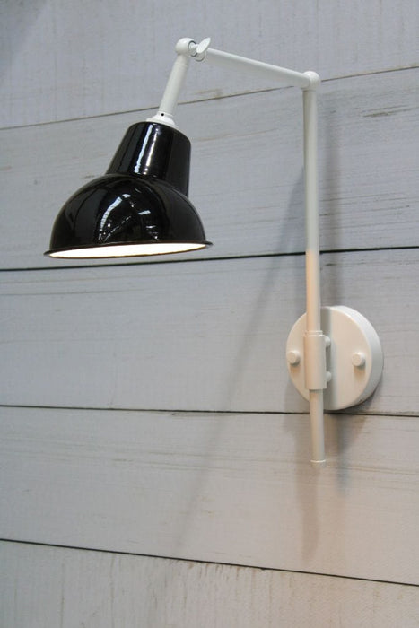 White wall sconce with black and white shade
