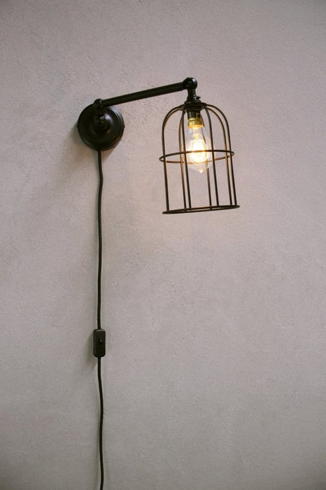 Plug-in wall light with black cage