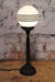 Matt black candlestick table lamp with four stripe shade