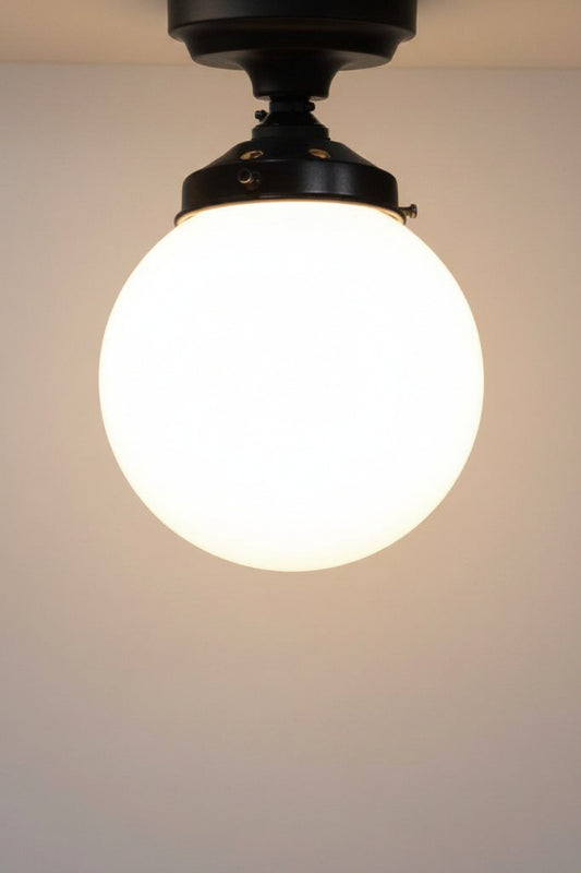 small opal glass ball ceiling light on black fitting
