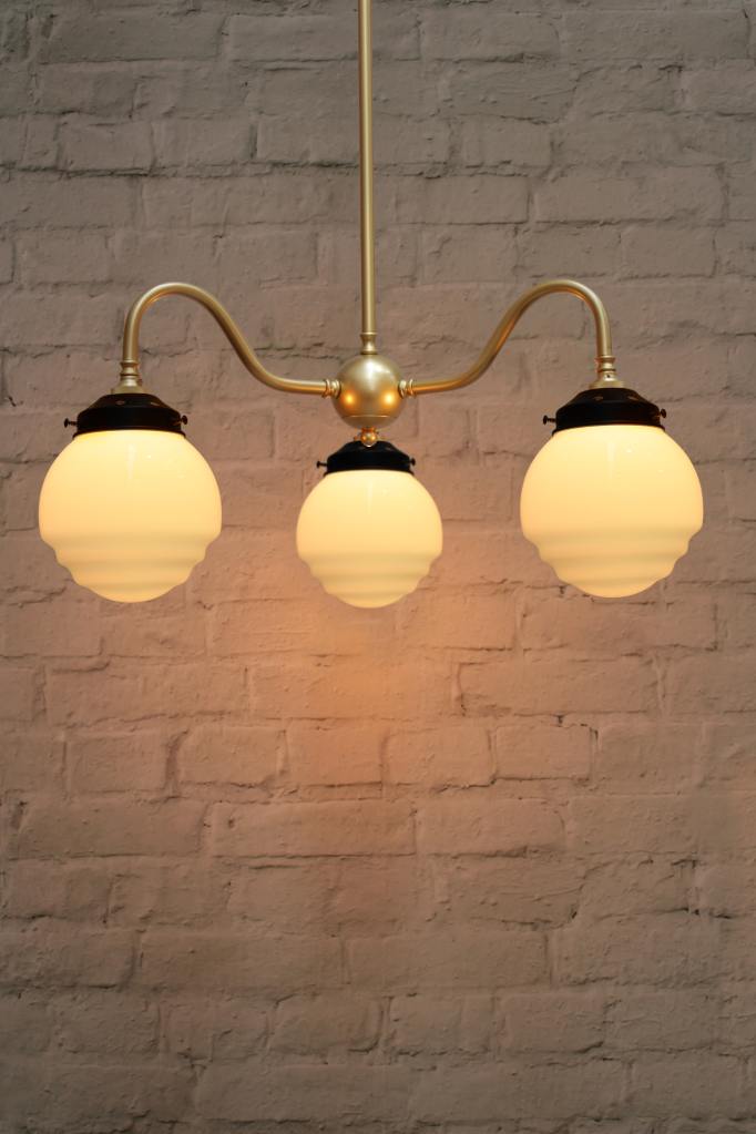 Gooseneck three light chandelier in gold/brass with ridged glass shades