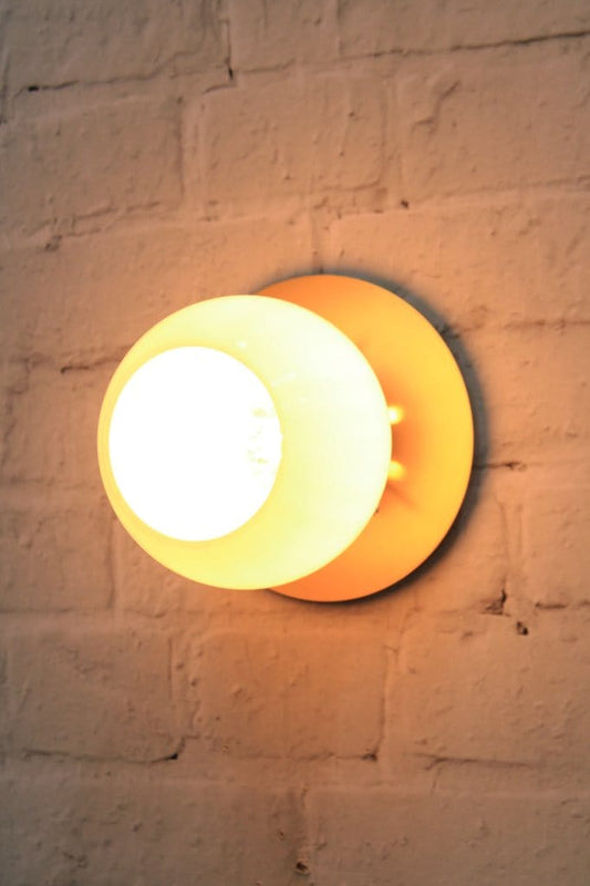 Small disc wall light with open glass shade