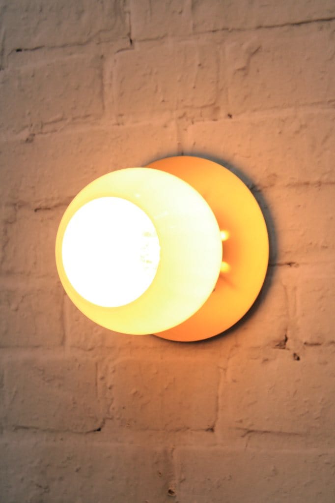 Small disc wall light with open glass shade