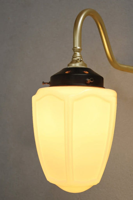 Glass shade with gold arm/chandelier close up