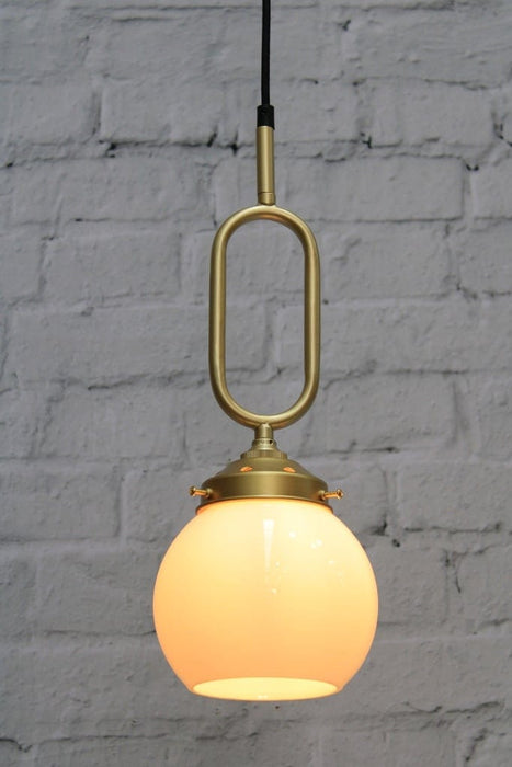 Small gold pendant light with matching gold gallery