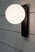 Opal glass wall light with black face plate