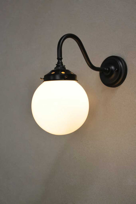 Small opal shade with black steel sconce