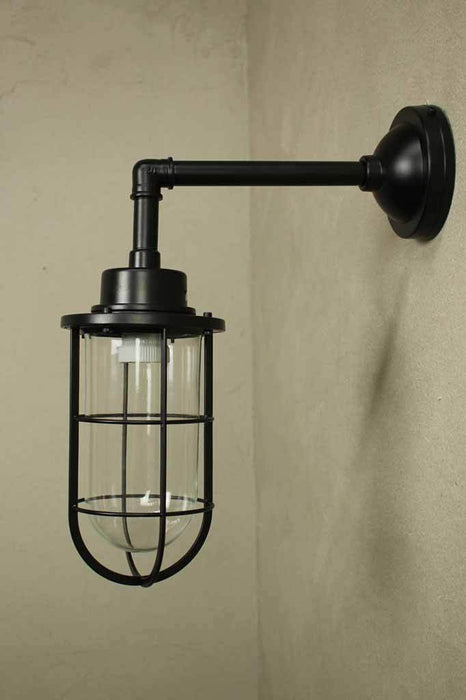Outdoor wall light suits interior and exterior styles. steel construction a glass shade with cage housing.