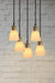 Gold/brass finish five light pendant with large ceramic shades