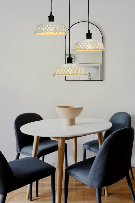 Three light pendant with white ceramic shades over dining table