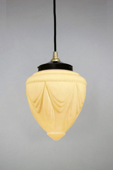glass pendant light with gold metal gallery and black round cord. 