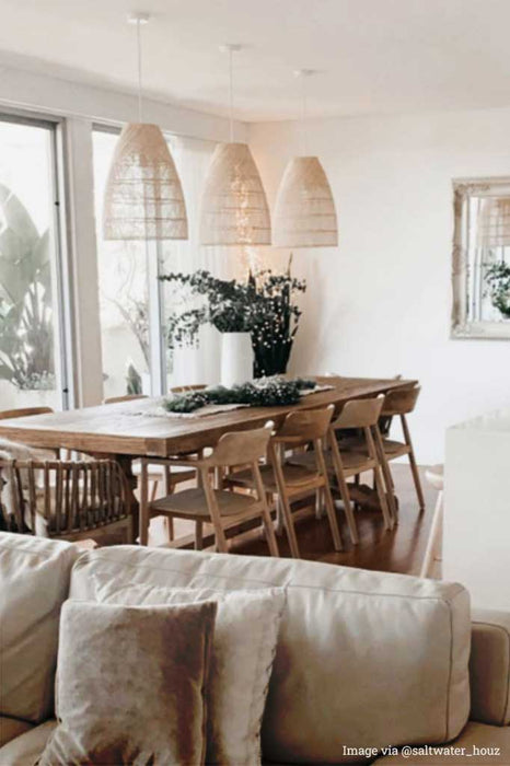 3 Rattan Pendant lights over a dining table.