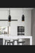 Two black metal pendant lights above a marble kitchen island