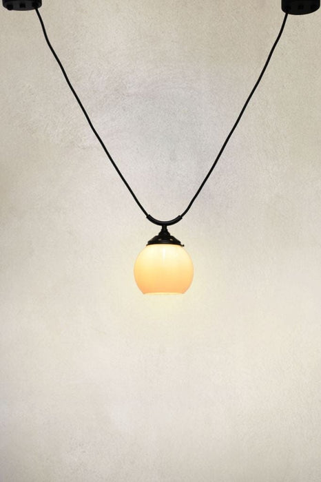 Small round open bottom opal glass shade with trapeze pendant cord