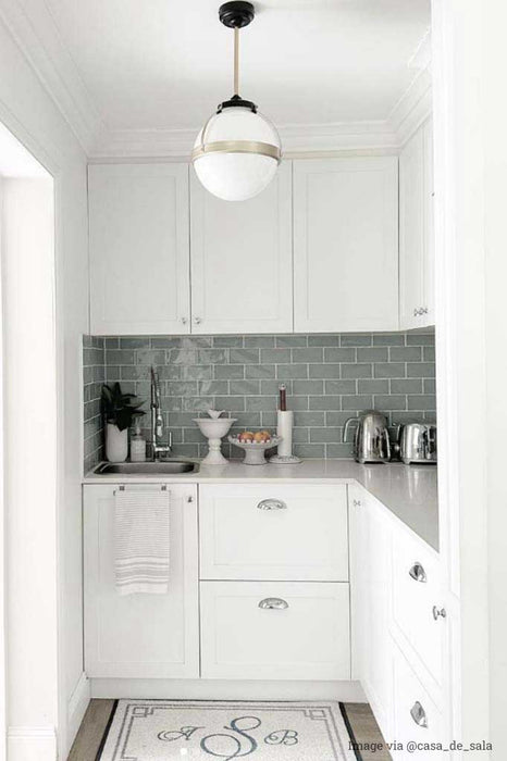 Huxley pendant with gold cord and medium opal shade in a kitchen.