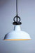 Pendant light with white small shade and black cord with disc