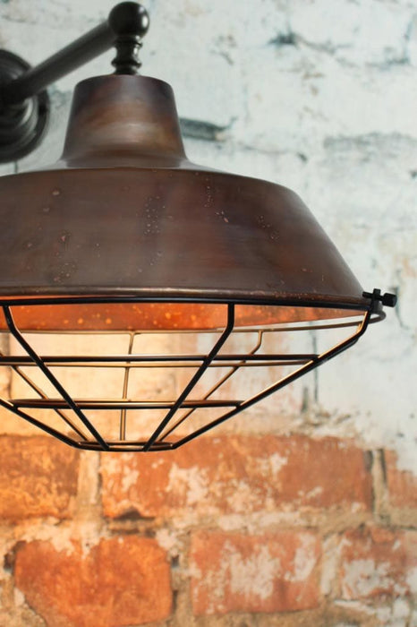 Pure copper wall light with black cage guard