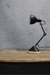 Small desk light with wooden base showing range of movement
