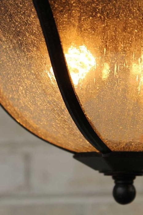 Regent outdoor ceiling light in antique bronze metal enchasing the glass