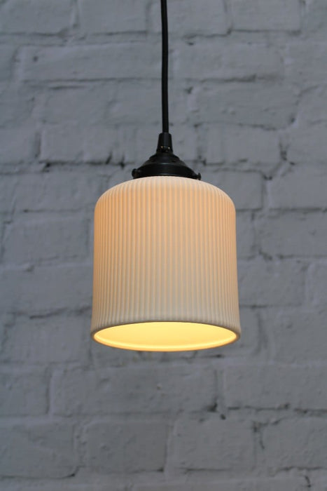 Ribbed ceramic pendant light with black gallery