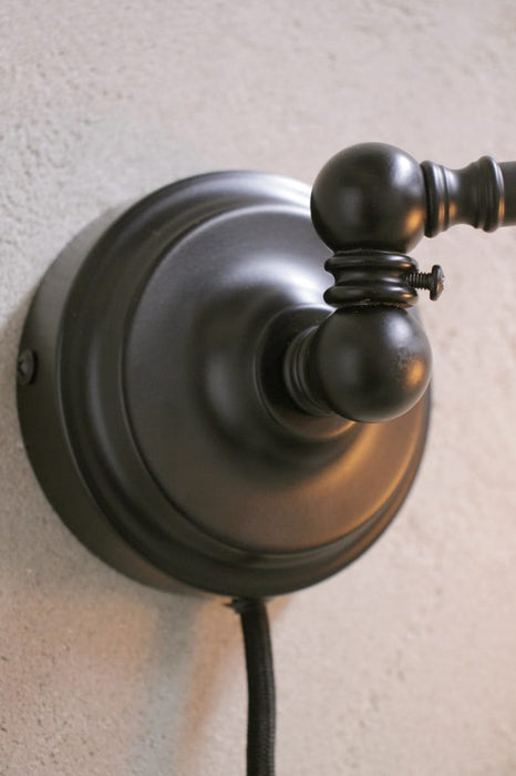 Plug in wall sconce with rotary joint