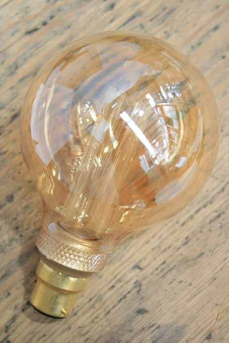 Round amber bulb with laser-cut LED filament
