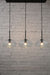 Three light linear pendant with oval shades and black ceiling rose