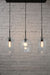Three light linear pendant with mixed shades A and black ceiling rose