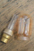Laser-cut filament amber LED bulb with glass unscrewed
