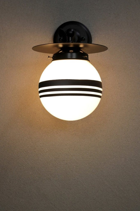 Small black adjustable steel wall light with three stripe shade