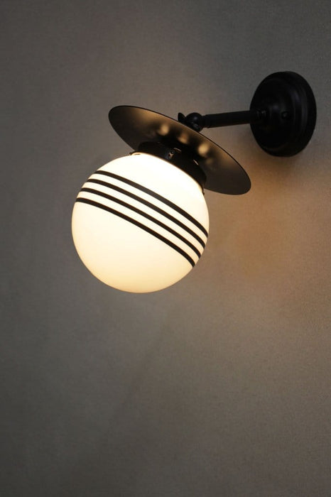 Small black adjustable steel wall light with four stripe shade