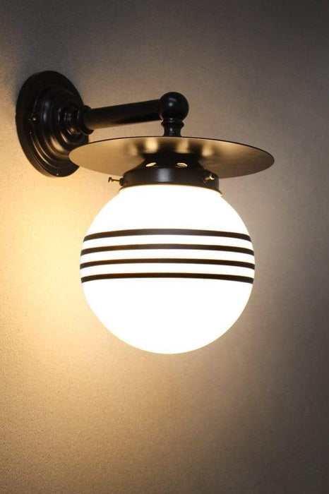 Small black brass wall light with opal four stripe shade