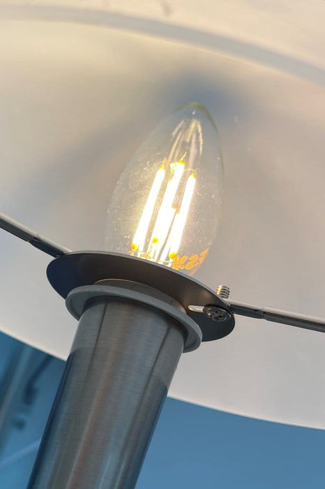 Bulb fitted in place underneath glass shade