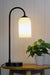 Table lamp with opal glass shade with cord visible. 