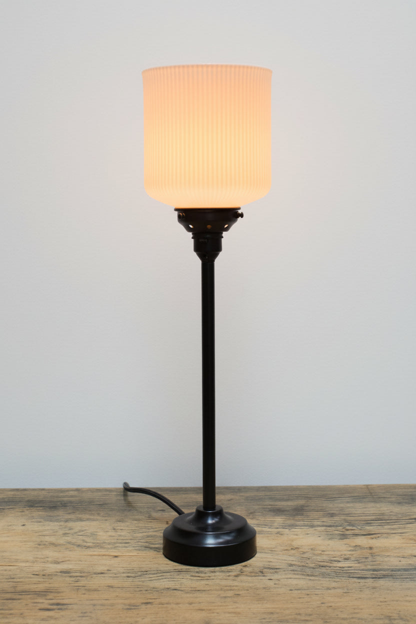 Ribbed ceramic shade with a black candlestick lamp base