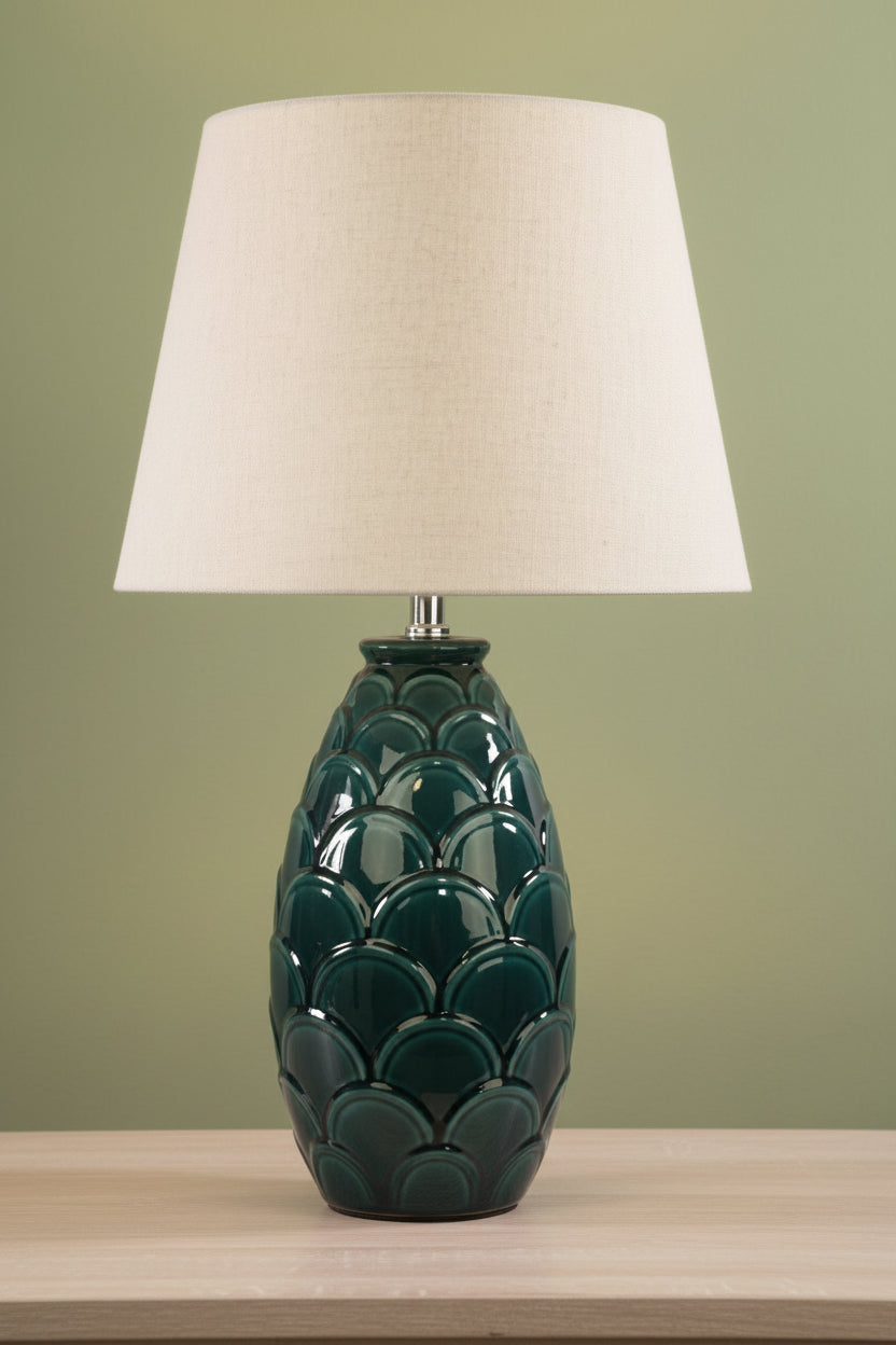 Table lamp with dark green base and tapered ivory shade