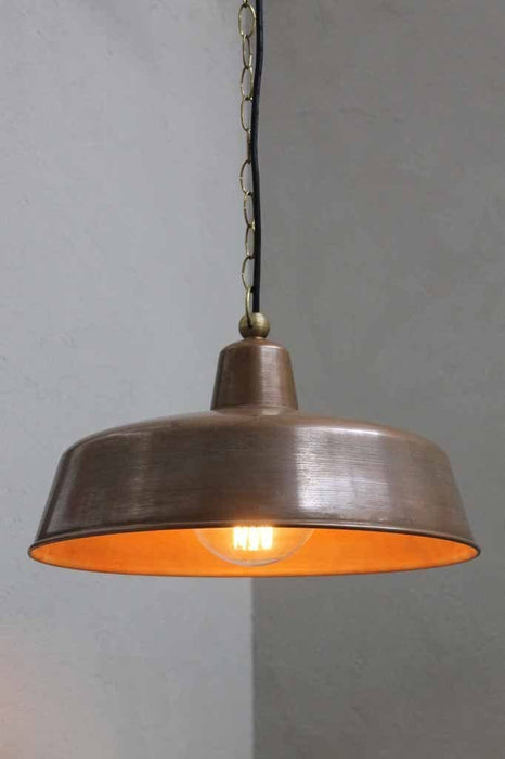 The outdoor copper pendant light is an aged copper shade pendant with a quality brass base and fittings