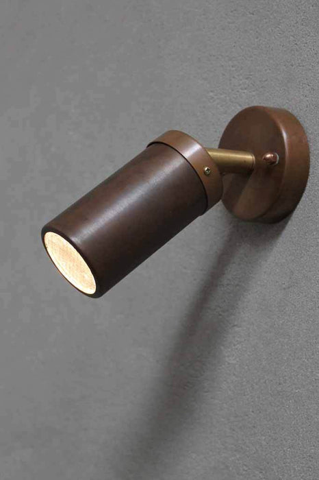 This copper outside led wall light is a single adjustable raw copper spotlight