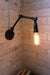Two arm swing wall lamp with teardrop edison bulb