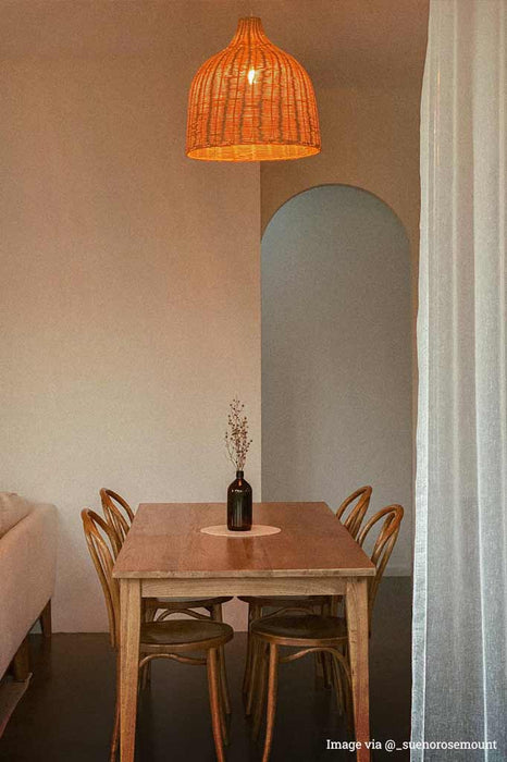 wicker pendant light over dining table