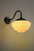 Black wall light with opal glass shade