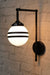 Black wall sconce with opal 2 stripe shade