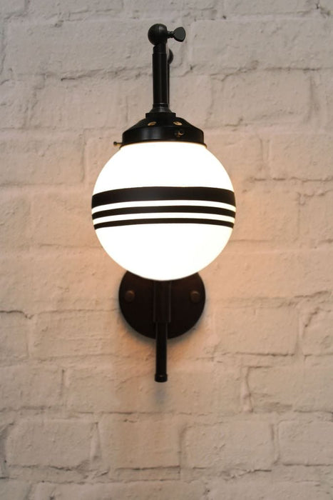 Black wall sconce with opal 3 stripe shade