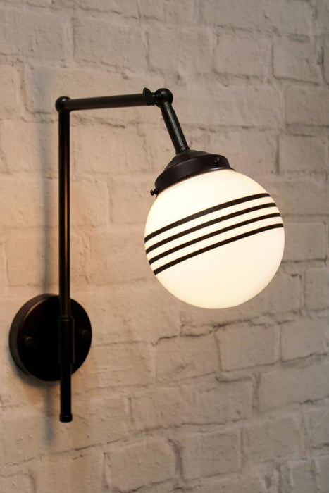 Black wall sconce with 3 stripe opal shade