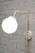 White wall sconce with small opal shade