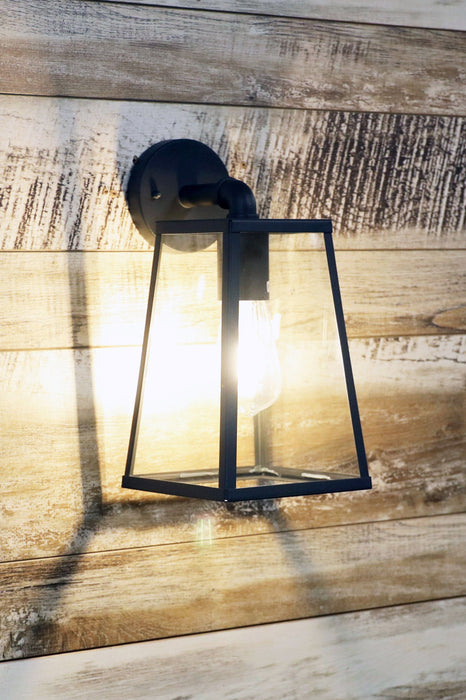 Outdoor graphite glass trapeze outdoor wall light on a wooden background