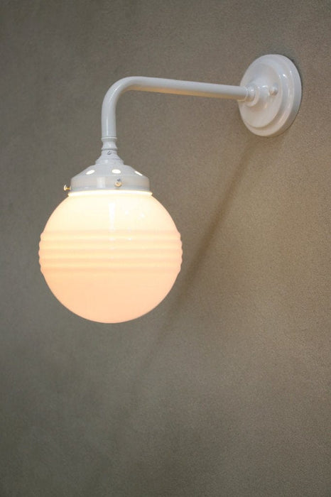 Steel wall light in a white finish with small ridged opal glass ball shade