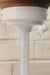 White pendant suspension pole on a wooden mounting block 