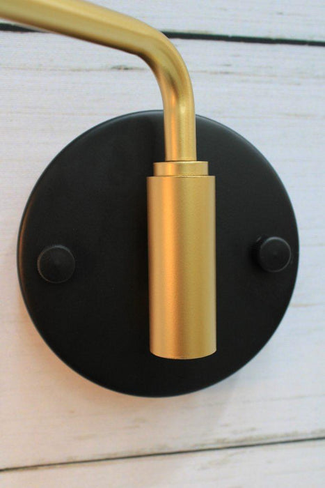 Wall sconce with swivel arm