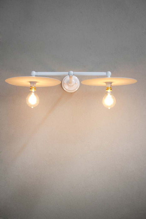 White double arm wall light with large white discs